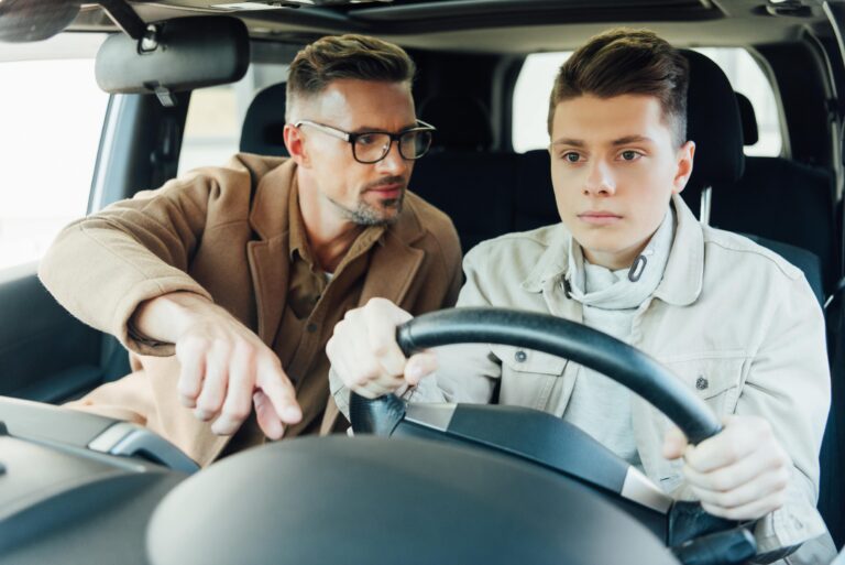 handsome-father-teaching-teen-son-driving-car-and-2024-11-09-05-47-57-utc-min