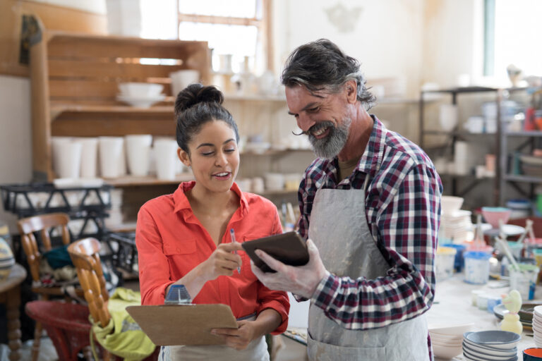 Blog - Bucher Insurance, Miamisburg, Ohio Male and female potter discussing over tablet pc in the pottery workshop